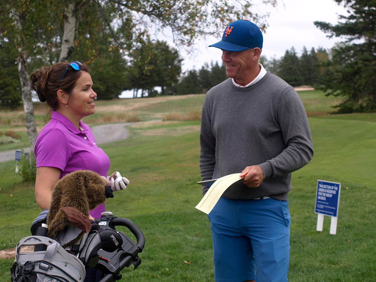 Man and woman golfer chatting